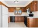 Well-lit kitchen with white countertop, wooden cabinets, and modern appliances at 3932 Villa Dr, Columbus, IN 47203