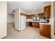 The kitchen features tiled floors, wooden cabinets, and modern appliances, next to the dining area at 3932 Villa Dr, Columbus, IN 47203
