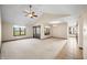 Bright living room with large windows and a ceiling fan at 3932 Villa Dr, Columbus, IN 47203