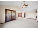 Open-concept living area with tile flooring and a ceiling fan at 3932 Villa Dr, Columbus, IN 47203
