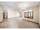 Bright living room featuring neutral walls, carpet, and vaulted ceiling with ceiling fan and chandelier at 3932 Villa Dr, Columbus, IN 47203