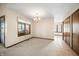 Inviting carpeted living room with natural light and classic chandelier for elegant dining at 3932 Villa Dr, Columbus, IN 47203