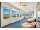Bright sunroom with multiple windows, ceiling fans, and comfortable wicker furniture at 3932 Villa Dr, Columbus, IN 47203