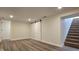 Basement with plank flooring, stairs, and sliding barn door at 4713 Calhoun St, Indianapolis, IN 46203
