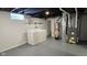 Unfinished basement featuring a laundry area and furnace at 4713 Calhoun St, Indianapolis, IN 46203