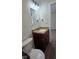 Bathroom features a vanity with granite countertop, toilet, wood-look floors, and updated lighting at 4713 Calhoun St, Indianapolis, IN 46203