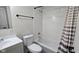 The bright bathroom features a white vanity and matching white tiled shower and tub combination at 4713 Calhoun St, Indianapolis, IN 46203