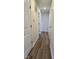 Hallway with neutral paint, wood-look floors, white doors with black hardware, and recessed lighting at 4713 Calhoun St, Indianapolis, IN 46203
