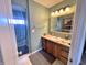 View of a bathroom with olive green walls, a sink with cabinets, a large mirror and a toilet room at 505 Birch St, Beech Grove, IN 46107