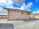 The back side of this brick single-story home features a well-maintained exterior and an expansive driveway at 505 Birch St, Beech Grove, IN 46107