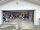 Shows a spacious garage with ample storage and workspace, perfect for projects and parking vehicles at 505 Birch St, Beech Grove, IN 46107