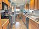Traditional eat-in kitchen with wood cabinetry, stainless steel appliances, and modern countertops at 505 Birch St, Beech Grove, IN 46107