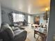 Comfortable living room featuring a large sofa and natural light with views into the dining area at 505 Birch St, Beech Grove, IN 46107