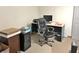 Features a desk and an office chair with file cabinets, a monitor, a printer, and other office accessories at 505 Birch St, Beech Grove, IN 46107