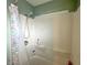 Features a clean shower with a white shower curtain with a fish design and a mounted shower head at 505 Birch St, Beech Grove, IN 46107