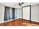 Bedroom featuring wood flooring, ceiling fan, and soft, modern curtains at 544 N Parker Ave, Indianapolis, IN 46201