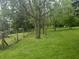 Expansive backyard with meticulously kept lawn, bordered by mature trees that offer privacy and natural beauty at 5533 Wilson Way, Jamestown, IN 46147