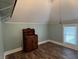 Bedroom with slanted ceiling, light blue walls, wood floors, and antique furniture at 5533 Wilson Way, Jamestown, IN 46147