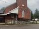 Red brick building with a ramp, offering accessibility, featuring arched window and a stone foundation at 5533 Wilson Way, Jamestown, IN 46147