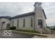 Traditional church featuring a stone facade, arched windows, and a prominent steeple topped with a cross at 5533 Wilson Way, Jamestown, IN 46147