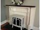 A charming electric fireplace with dark wood mantle and decorative wreath accent at 5533 Wilson Way, Jamestown, IN 46147