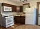 This kitchen boasts stainless steel appliances, ample counter space, and stylish wood cabinets at 5533 Wilson Way, Jamestown, IN 46147