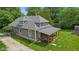 Back view of a gray home with a covered porch, showcasing its classic architectural design at 5533 Wilson Way, Jamestown, IN 46147
