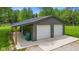 A spacious two-car garage with gray siding and a lean-to area, perfect for parking and storage at 5533 Wilson Way, Jamestown, IN 46147