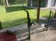 Vintage water well pump set upon the concrete porch, evoking old-fashioned charm amidst serene outdoors at 5533 Wilson Way, Jamestown, IN 46147