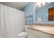 Clean bathroom with tiled floor, granite vanity, and shower with curtain at 6440 Watercrest Way, Indianapolis, IN 46278