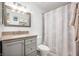 Bathroom featuring a vanity with a granite countertop, a mirror, and a shower with a curtain at 6440 Watercrest Way, Indianapolis, IN 46278