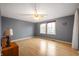 Bedroom with neutral paint, wood floors, natural light, and a ceiling fan at 6440 Watercrest Way, Indianapolis, IN 46278