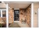 Inviting front porch with brick accents and a cozy chair, perfect for relaxing at 6440 Watercrest Way, Indianapolis, IN 46278