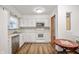 Well-maintained kitchen featuring white cabinets, appliances, and tile accents at 6440 Watercrest Way, Indianapolis, IN 46278