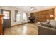 Comfortable living room with a wood accent wall, large windows, and hardwood floors perfect for relaxing or entertaining at 6440 Watercrest Way, Indianapolis, IN 46278