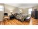 Spacious main bedroom with hardwood floors and soft natural light creating a relaxing and inviting atmosphere at 6440 Watercrest Way, Indianapolis, IN 46278