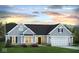 Charming single-story home showcasing blue siding, well-manicured lawn, and a convenient two-car garage at 651 Rylan Cir, Greenwood, IN 46142