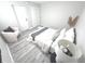 Bedroom with neutral tones and a modern design, complemented by natural textures and light wood floors at 7807 Inverness Dr, Indianapolis, IN 46237