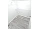 Walk-in closet with installed wire shelving and wood-look flooring, offering organized storage space at 7807 Inverness Dr, Indianapolis, IN 46237