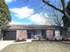Charming brick home featuring a well-maintained front yard and an attached garage at 7807 Inverness Dr, Indianapolis, IN 46237
