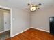 Neutral bedroom features hardwood floors and unique ceiling fan at 812 Madison St, Frankton, IN 46044