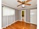 Bedroom features hardwood floors, a ceiling fan, and doorway to the bathroom at 812 Madison St, Frankton, IN 46044