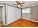 Bedroom featuring hardwood floors, a ceiling fan, double closets, and bright natural light at 812 Madison St, Frankton, IN 46044