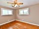 Bright bedroom featuring hardwood floors, neutral paint, and two windows at 812 Madison St, Frankton, IN 46044