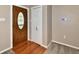 Welcoming entryway featuring hardwood floors, a decorative front door, and neutral wall paint at 812 Madison St, Frankton, IN 46044