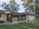 A charming single-story home with a porch, attached garage, and well-maintained lawn at 812 Madison St, Frankton, IN 46044