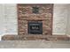 Close-up of the brick fireplace featuring a decorative mantel and hearth at 812 Madison St, Frankton, IN 46044