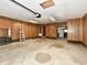 Spacious garage with wood paneling, shelving, and ladder for storage and organization at 812 Madison St, Frankton, IN 46044