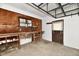 Functional garage with workbench, storage, and rear exit door, providing convenience and utility at 812 Madison St, Frankton, IN 46044