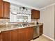 Kitchen with sink, stainless steel dishwasher, countertops, window, and cabinets at 812 Madison St, Frankton, IN 46044